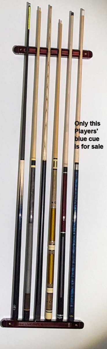 Cues on wall showing off the Players cue.jpg