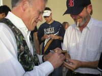 Scott Smith signing cigar at Open.JPG