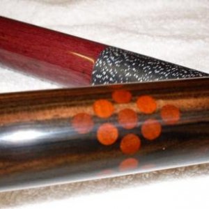 1995 Dave Tice. 12pt with 4 racks of 9 in the butt.
Dave made the cue for me in 95, 
The rack of nine in the butt is African Padauk and ebony.
The but