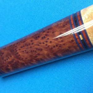 Wenge, and Jatoba rings, Burled Redwood butt sleeve.  Looks like it is on fire