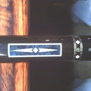 Dave Jones
The blue inlay is pressure stained Madrona Burrell.
everything that is white in the cue is real ivory. 
Stack layered leather wrap.
it play