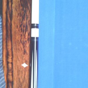 Dave Jones,
The blue inlay is pressure stained Madrona Burrell.
everything that is white in the cue is real ivory. 
Stack layered leather wrap.
it pla