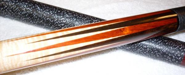 1995 Dave Tice... Dave made the cue for me in 95,
12pt  African Padauk / Black Limba with eastern fiddle back maple forearm.  Dave Jones refinished th
