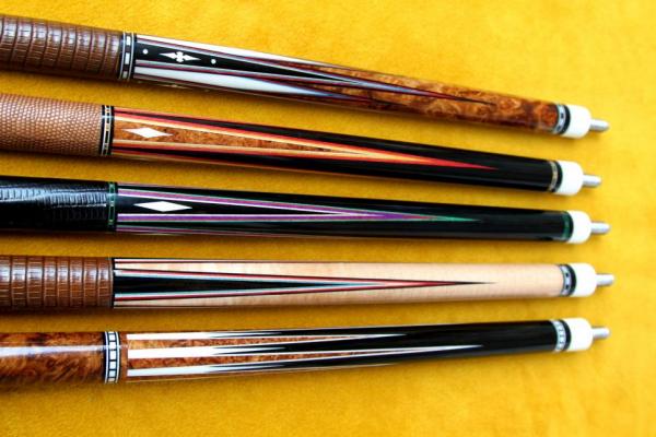 A group of JD Custom Cues from Toonmy Q's