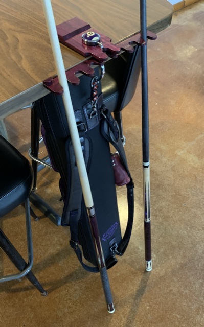 Case hanging from cue rest