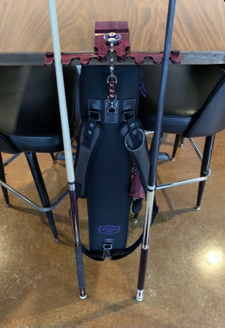 Case hanging from cue rest