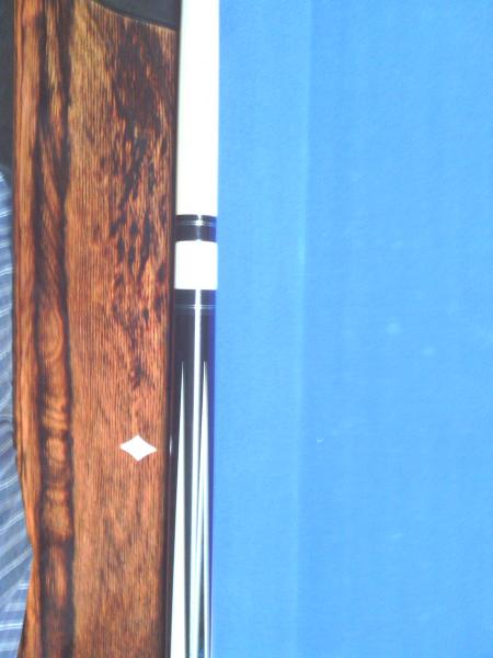 Dave Jones,
The blue inlay is pressure stained Madrona Burrell.
everything that is white in the cue is real ivory. 
Stack layered leather wrap.
it pla
