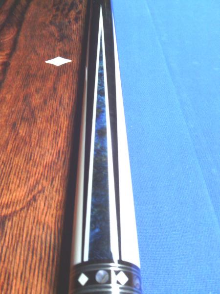 Dave Jones
The blue inlay is pressure stained Madrona Burrell.
everything that is white in the cue is real ivory. 
Stack layered leather wrap.
it play