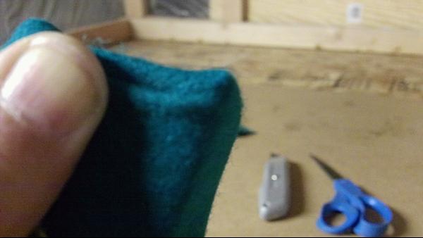 Fold flap over and staple. Go to the angle end and do the same. Staple the remainder of the cloth (top of rail).