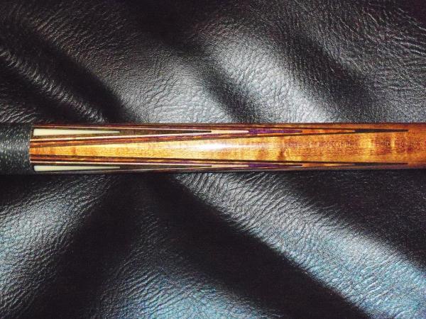 Joss 95-09 Forearm: Triangle inlay, Black, Natural, Purple, Brown, & Black veneers in the points.
20.4 ounce cue; no weight bolt. I have a Predator Z 