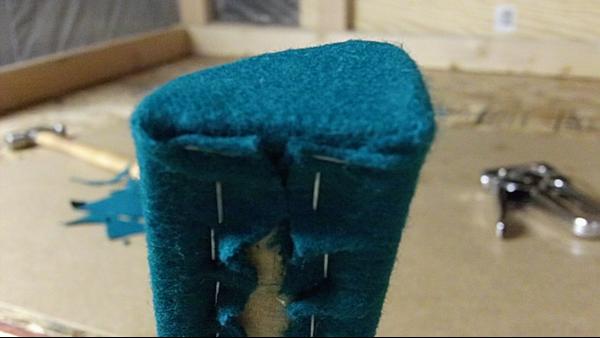 Repeat the process for the bottom of the rail. Pull cloth snug as you go. Excess cloth trimmed and sits inside the recess in back of the rail.