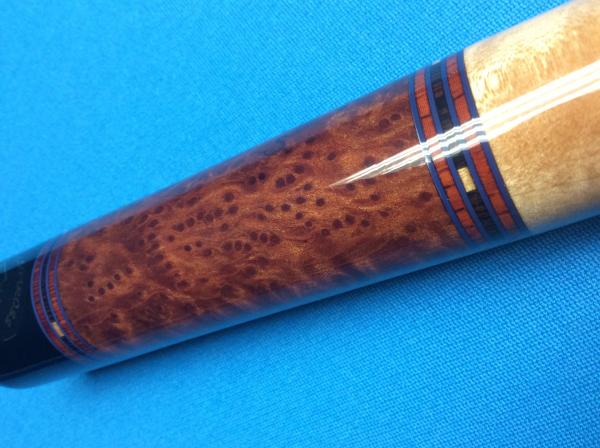 Wenge, and Jatoba rings, Burled Redwood butt sleeve.  Looks like it is on fire